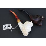 A vintage pipe with the bowl carved in the form of a bull and a meercham pipe man in turban.