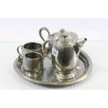 Four piece Tudric hammered Pewter tea set with a similar hammered Pewter tray