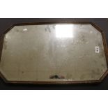 An antique octaginal oak framed mirror with beveled edge