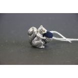 A silver pincushion in the form of a squirrel