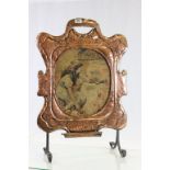 Copper Art Nouveau fire screen with painted central panel on wood