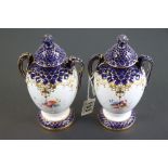 Pair of lidded Royal Worcester Leadless Glaze twin handled vases with hand painted floral decoration