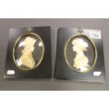 Pair of Wax relief portraits by Leslie Ray in rectangular black lacquer frames