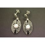 A pair of silver marcasite and onyx earrings with central opal panel