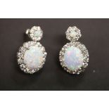 A pair of large silver CZ and opal earrings