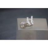 A 14ct white gold ring with large white topaz and white sapphire shoulders