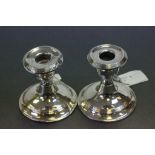 A pair of dwarf candlesticks, Birmingham 1911, weighted