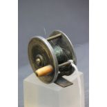 A vintage brass and metal centrepin fishing reel.