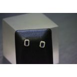 A pair of 9ct white gold sapphire and diamond earrings of 1ct total weight