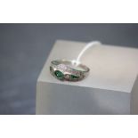 A 14ct white gold emerald and diamond ring in the art deco style