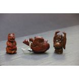 Three oriental wooden figures and a snuff bottle