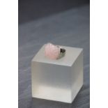 A silver and rose quartz ring decoratively carved