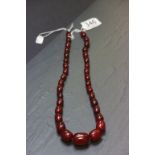 A cherry amber bakelite graduating bead necklace