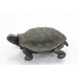 A novelty spelter inkwell in the form of a tortoise.