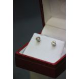 A pair of 14ct white gold diamond stud earrings of 80 points