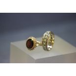 9ct Gold Garnet set dress ring and a yellow metal Eternity ring