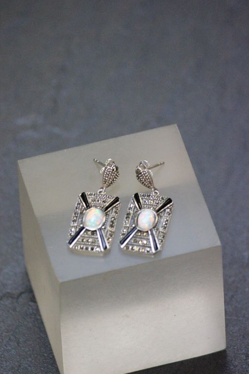 A pair of silver rectangular art deco style earrings with opal panel