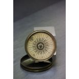 A brass cased compass