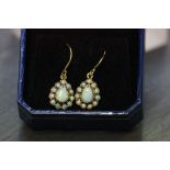 A pair of 9ct yellow gold and opal pear shaped earrings