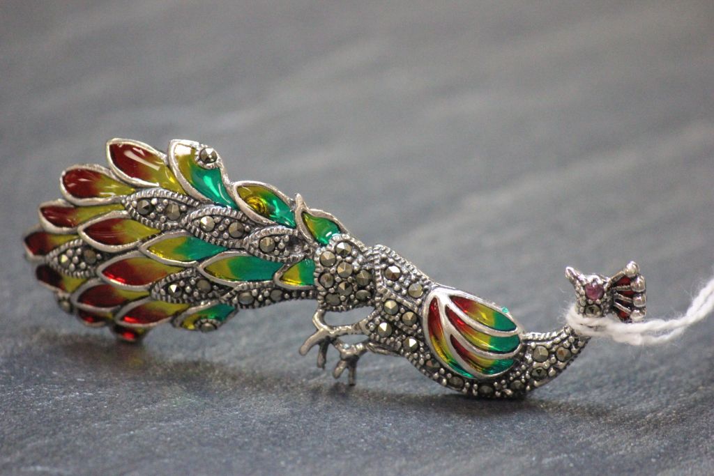 An impressive silver plique a jour peacock brooch