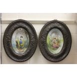 Pair of French wall plaques with copper frames & hand painted ceramic scenes to centre