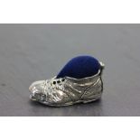 A silver Victorian style boot pin cushion