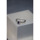 An 18ct white gold sapphire and diamond cluster ring of 90 points