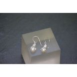 A pair of silver and freshwater pearl earrings in the form of a squid