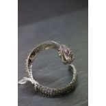 An unusual silver marcasite bangle with snake head inset with ruby eyes in the form of a watch