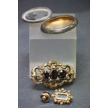 Two 19th Century yellow metal brooches, a yellow metal cufflink and a hallmarked Silver compact