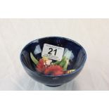 Small Moorcroft bowl with flower design and label to base reading "Potters to the late Queen Mary"