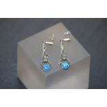 A pair of silver drop earrings set with blue opal panels