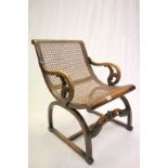 Early 20th century Walnut Bergere Chair with Carved Scroll Arms and D Shaped SupportsEarly 20th