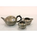 A three piece pewter Tudric tea set..