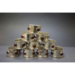 Set of Ten Arts and Crafts Style Silver Plated Napkin Rings each set with four cabouchon glass