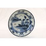 An 18th century blue and white tin glazed Delft charger with garden decoration.