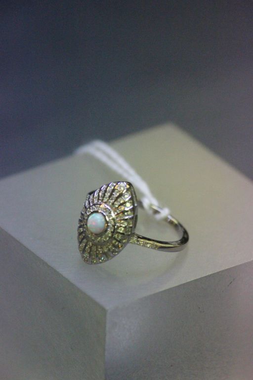 A silver CZ art deco style ring with central opal