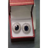 A pair of silver CZ and substantial sapphire earrings