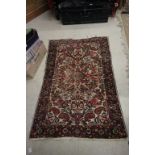 Small Eastern Pink Ground Rug with stylised floral pattern