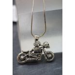 A novelty silver motorcycle rider by a skeleton on silver chain