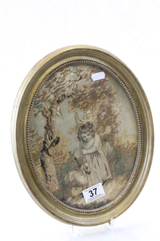 An antique oval silk picture of young girl with sheep.