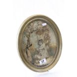 An antique oval silk picture of young girl with sheep.