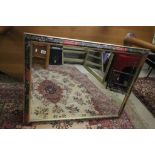 A very large bevelled glass overmantle mirror