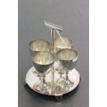A Christopher Dresser style silver plated egg cups and stand.