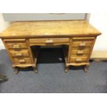 Hardwood Bankers desk with 2 pedestal units containing drawers and a single long drawer to the