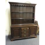 18th century design oak dresser, the bottom section containing 2 cupboards and 3 short drawers on