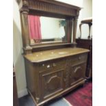 Art Nouveau period Liberty inspired dresser, large oak panelled decorated back with a bevelled