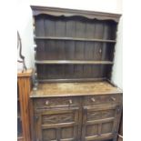 Oak Welsh style dresser with carved decoration, plate rack area to the back with cupboards and