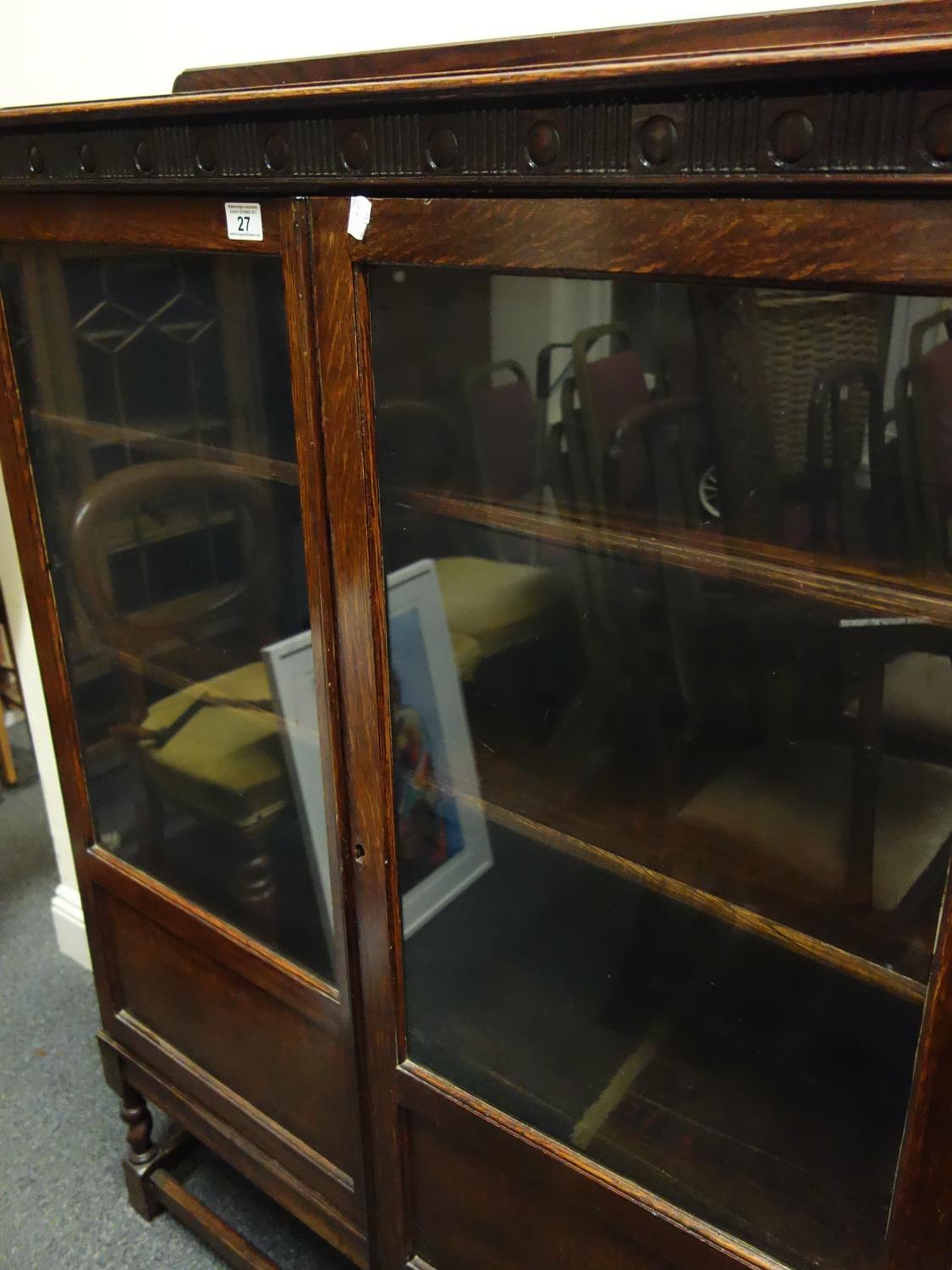 1920's oak show cabinet with twin glazed doors to the front and graduating shelving enclosed on a