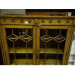 Oak Edwardian period display cabinet on a raised base, with twin glazed doors to the front,